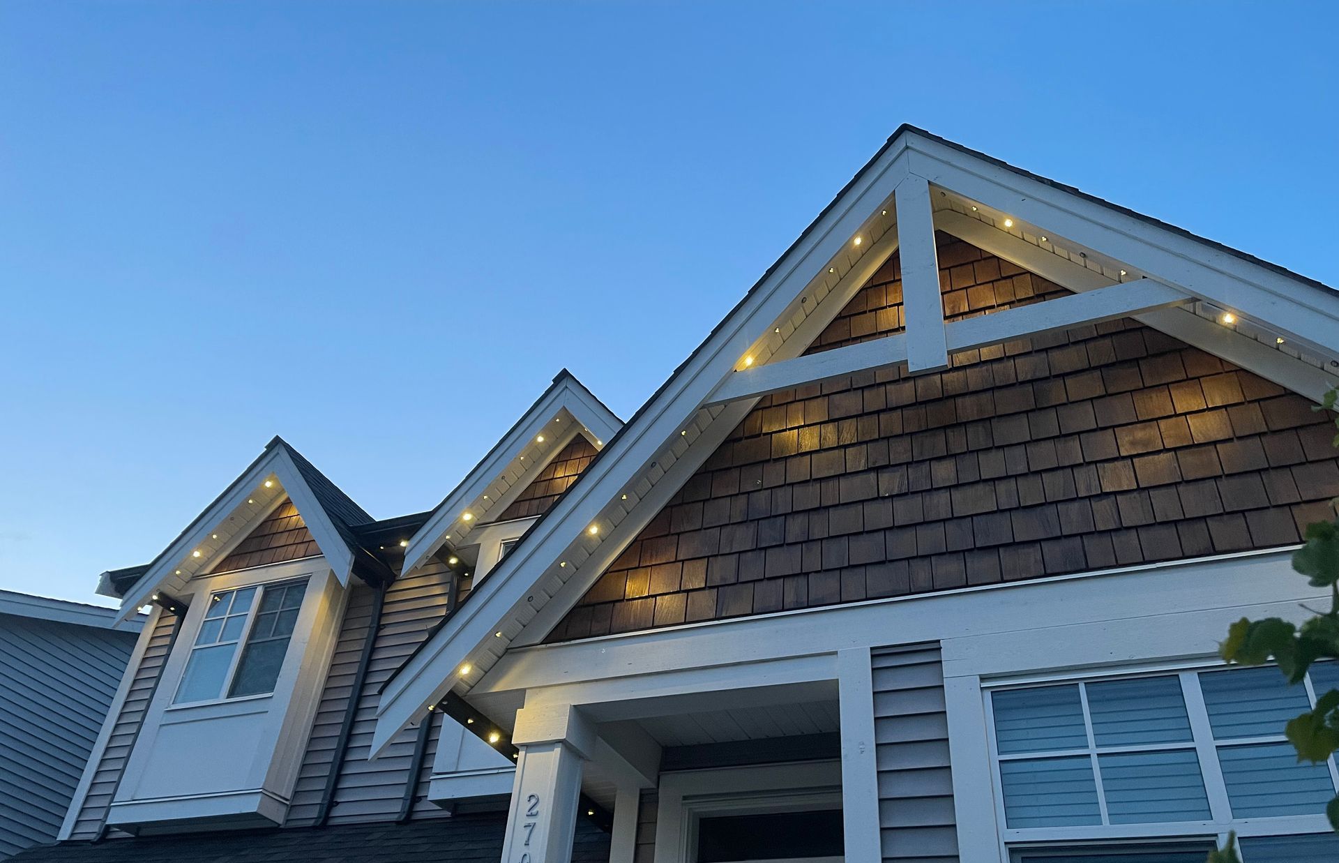 A row of houses are lit up at night in a residential area