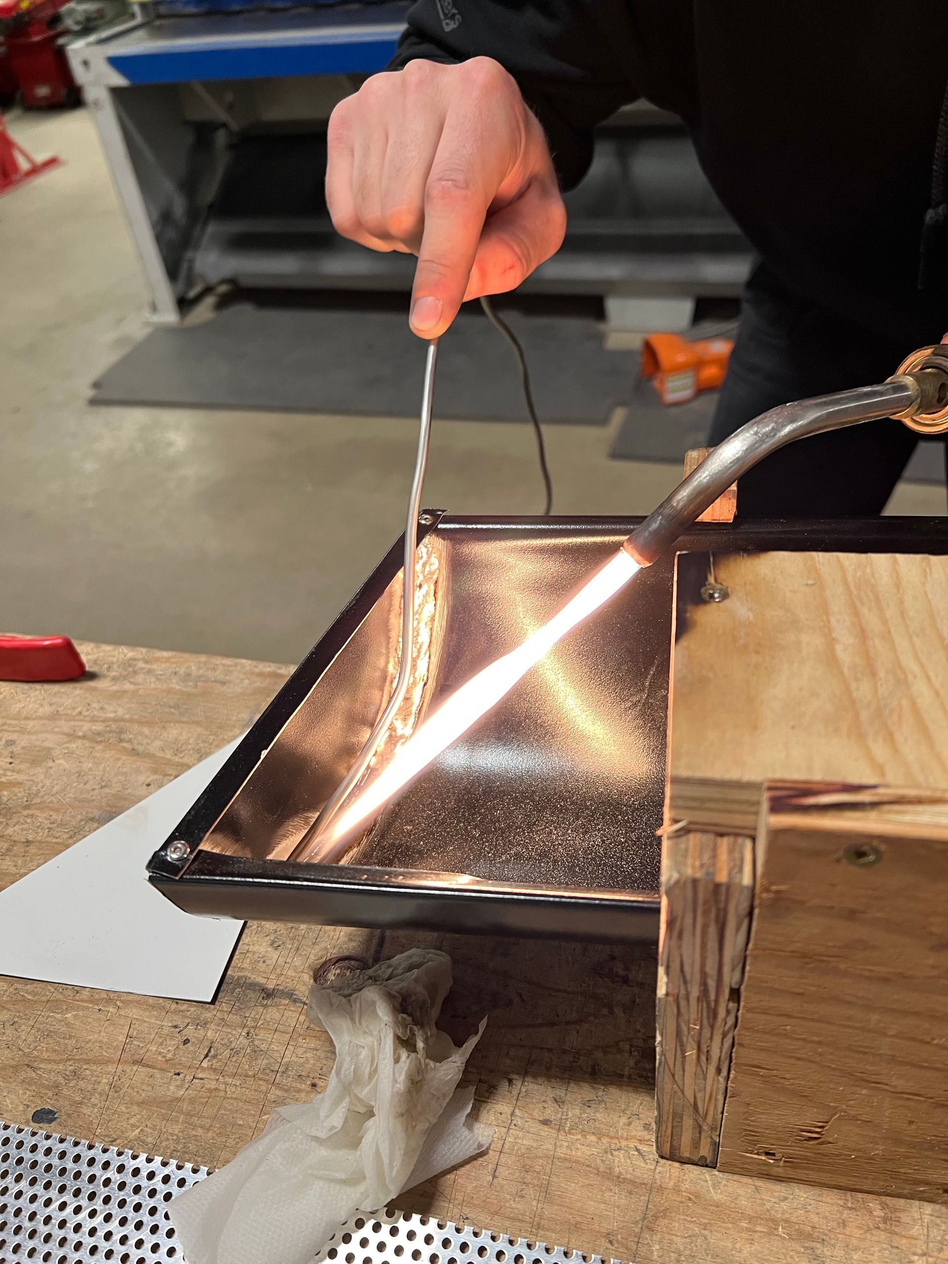 A person is cutting a piece of metal with a torch
