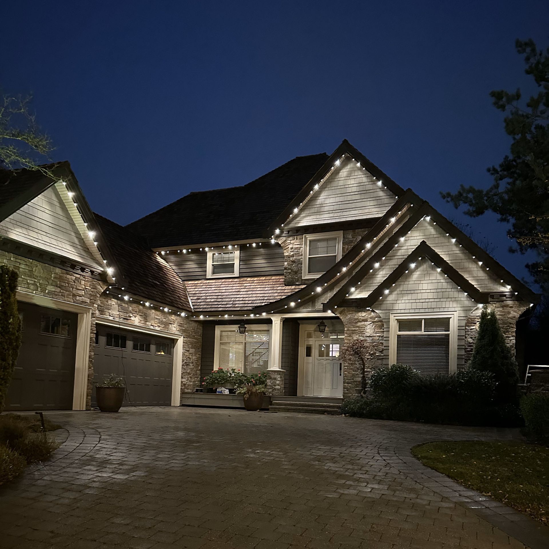 A house is lit up with christmas lights at night