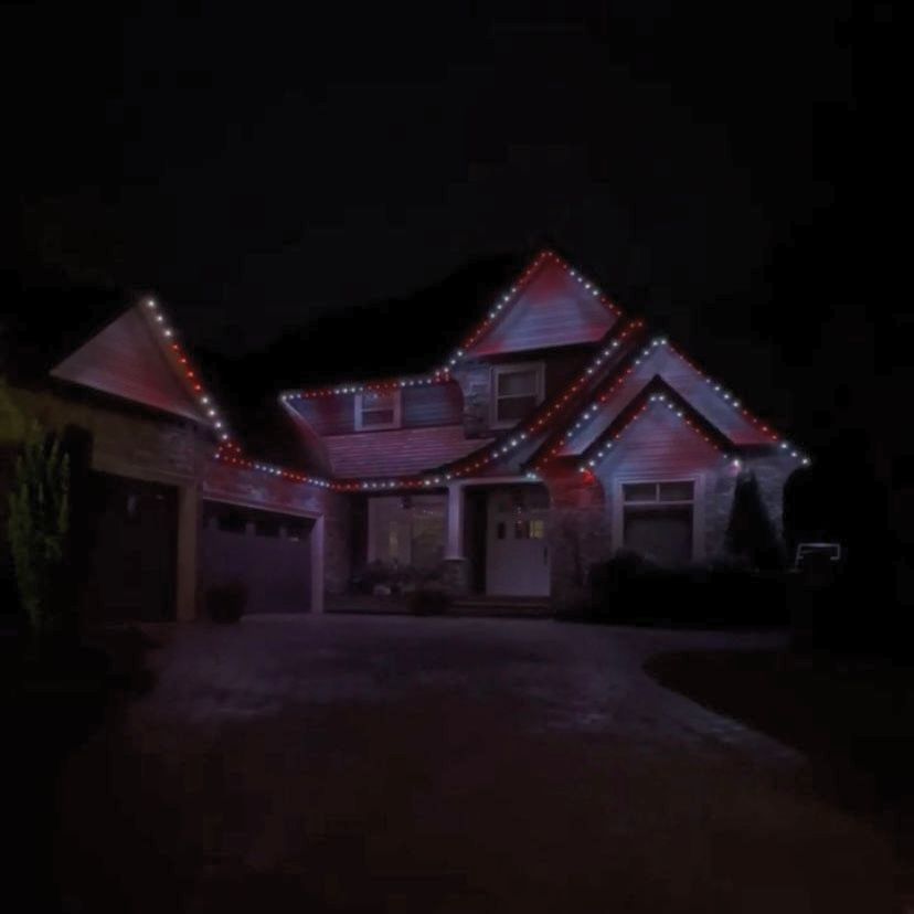 A house with christmas lights on it at night