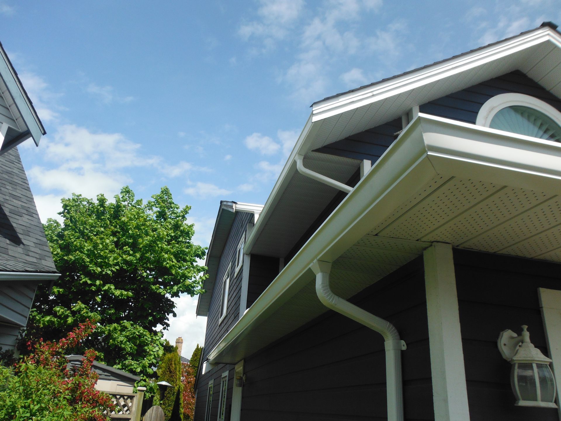 A black and white house with a white gutter