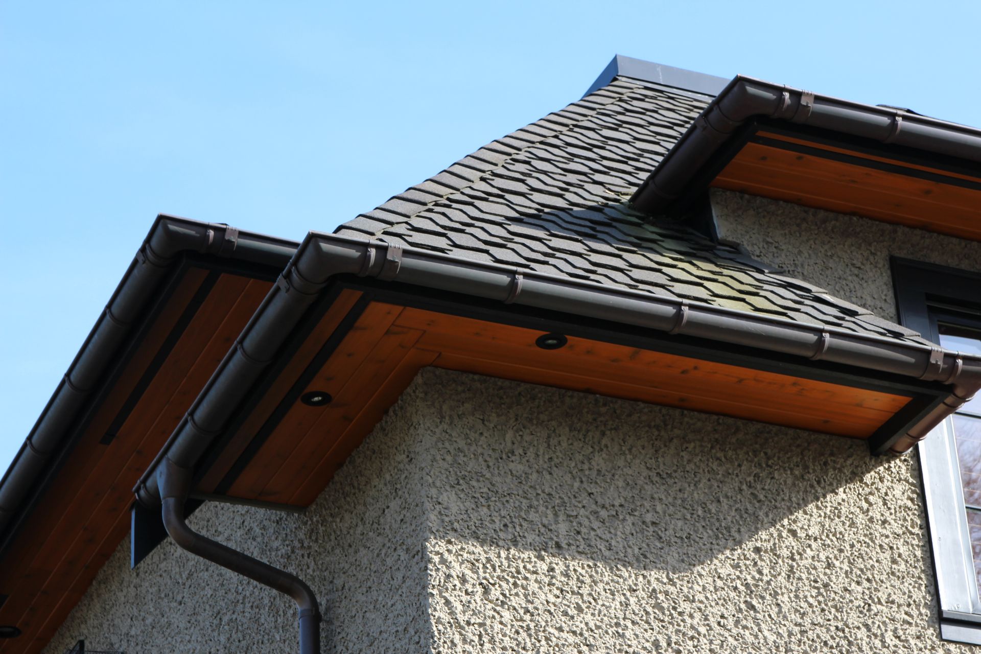 A house with a gutter on the side of it