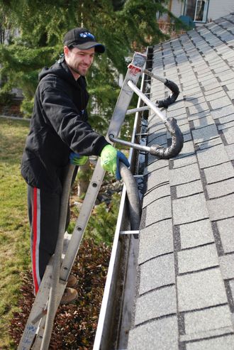 man cleaning gutter