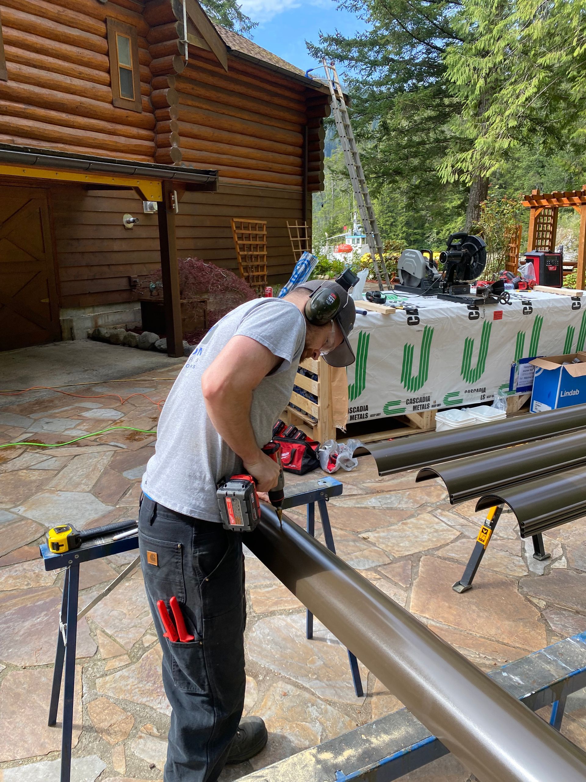 worker installing gutter pipeline