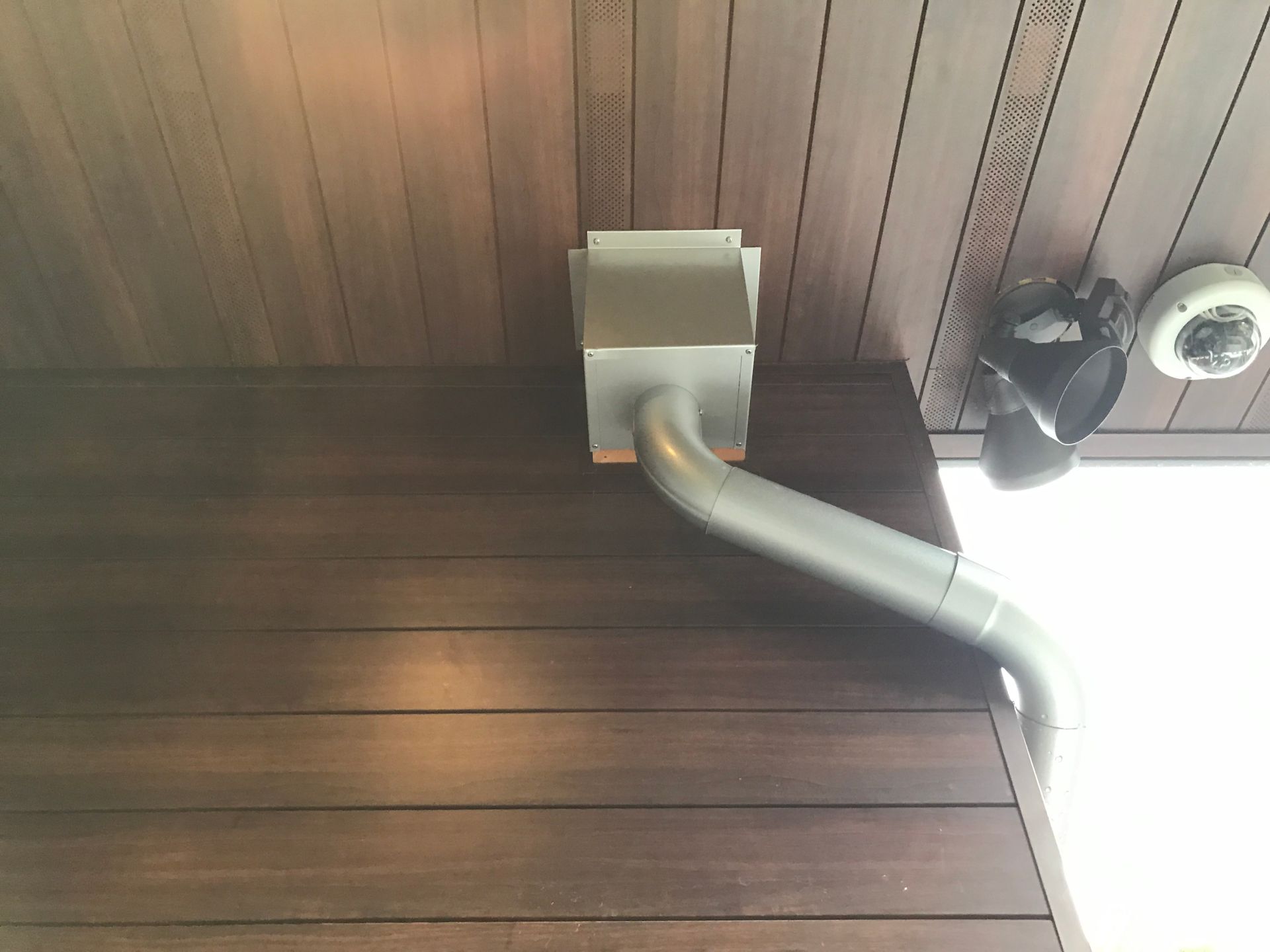 A rain gutter is attached to the side of a building.