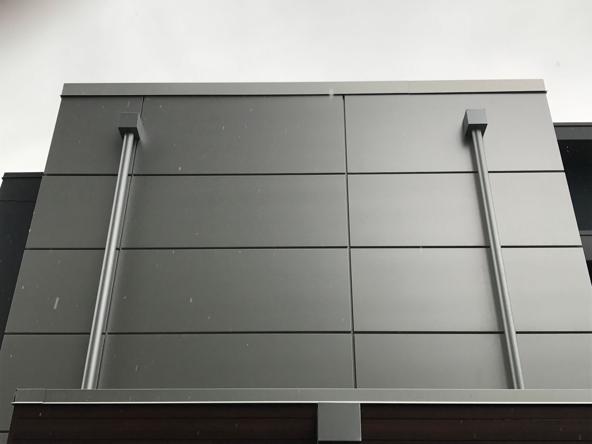 Looking up at a building with a gray facade