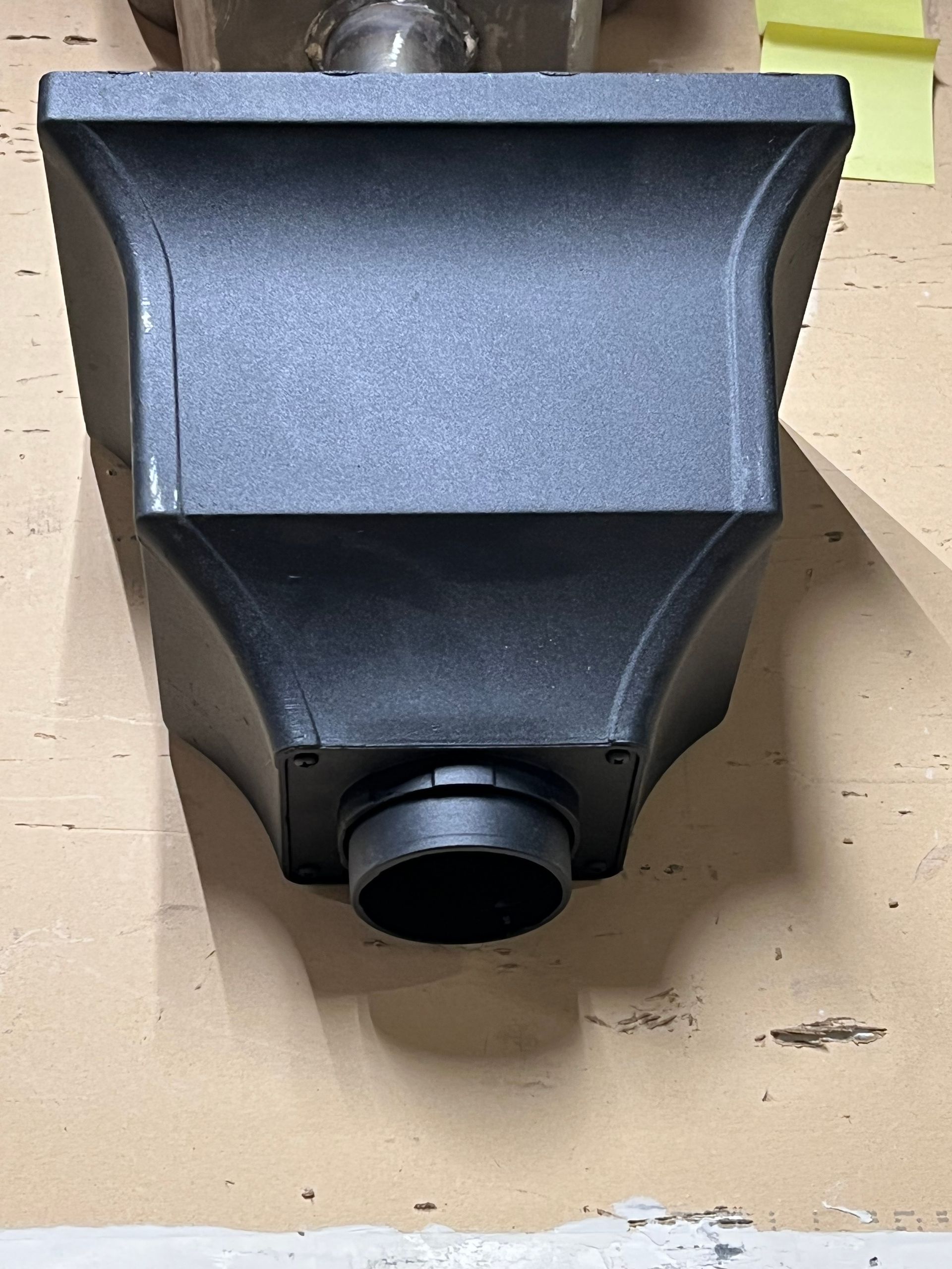 A black box with a hole in the middle is sitting on a table