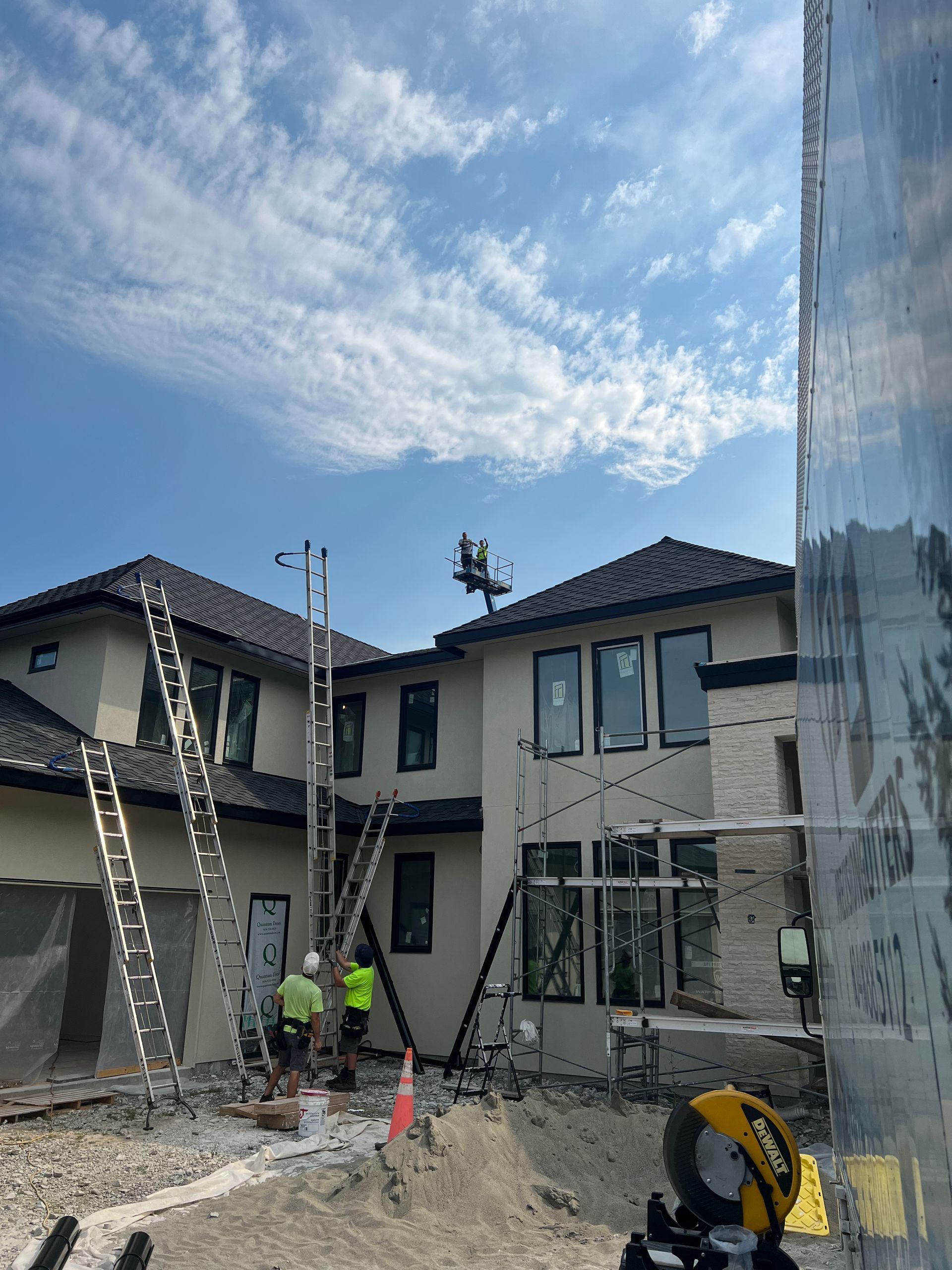 A large house is being built with a lot of scaffolding around it.