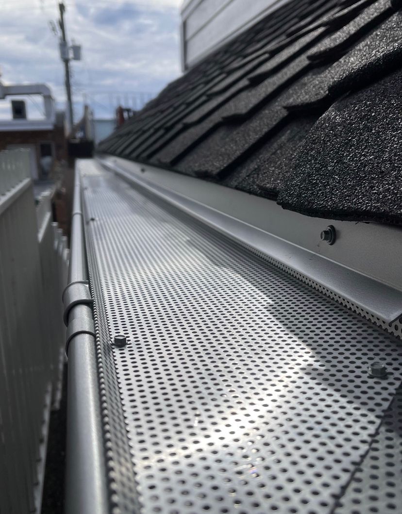 A close up of a metal gutter on a roof.