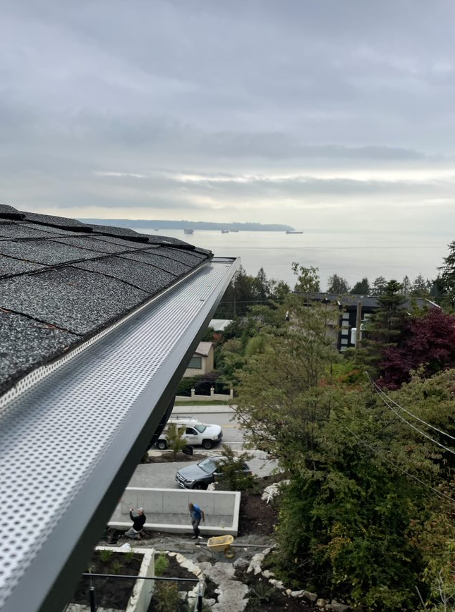 An aerial view of a roof with a view of the ocean.