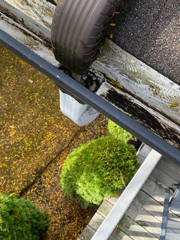 An aerial view of a gutter with a tire hanging out of it.