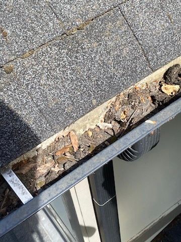 A close up of a gutter on a roof.