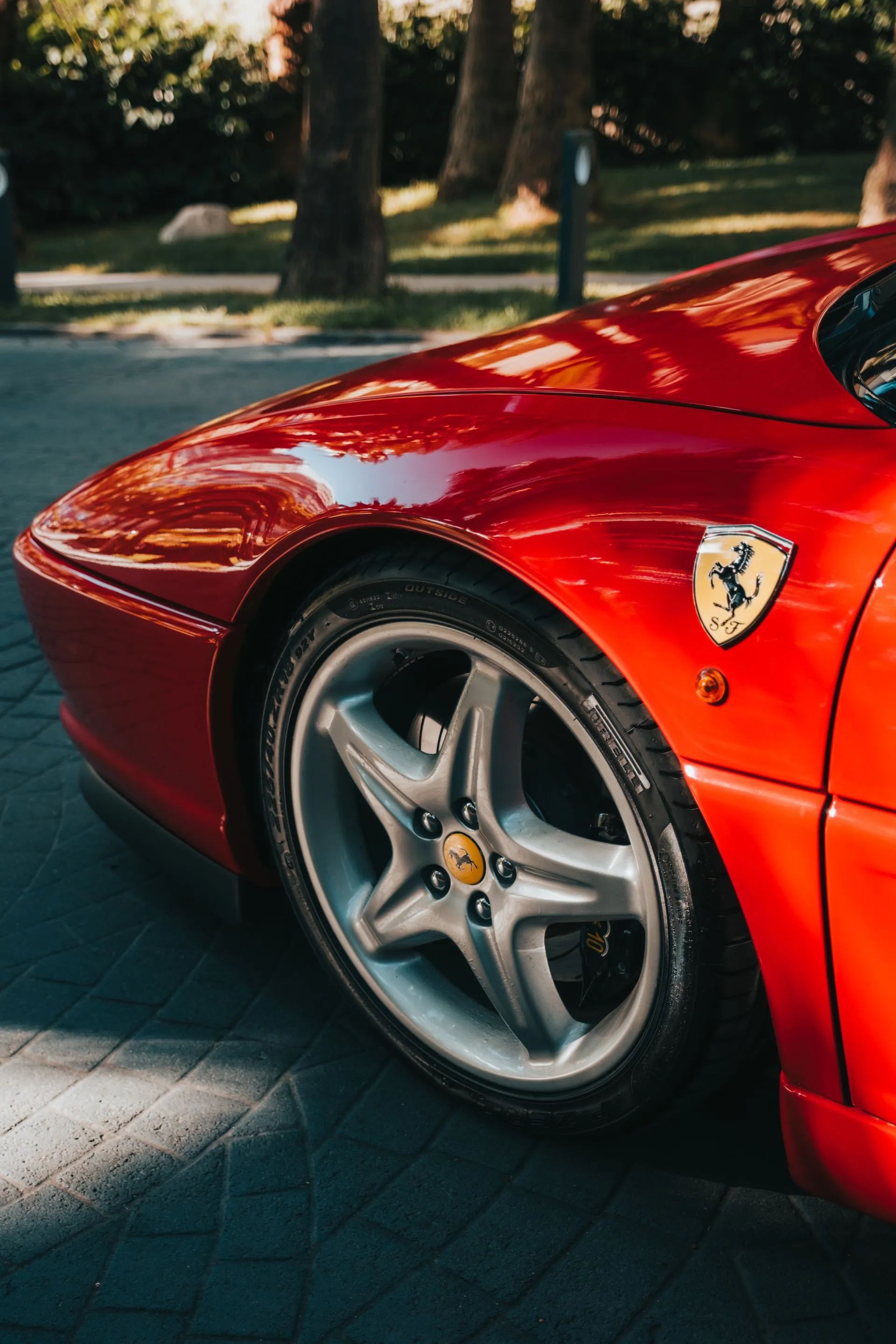 A red toyota sports car is driving down a road