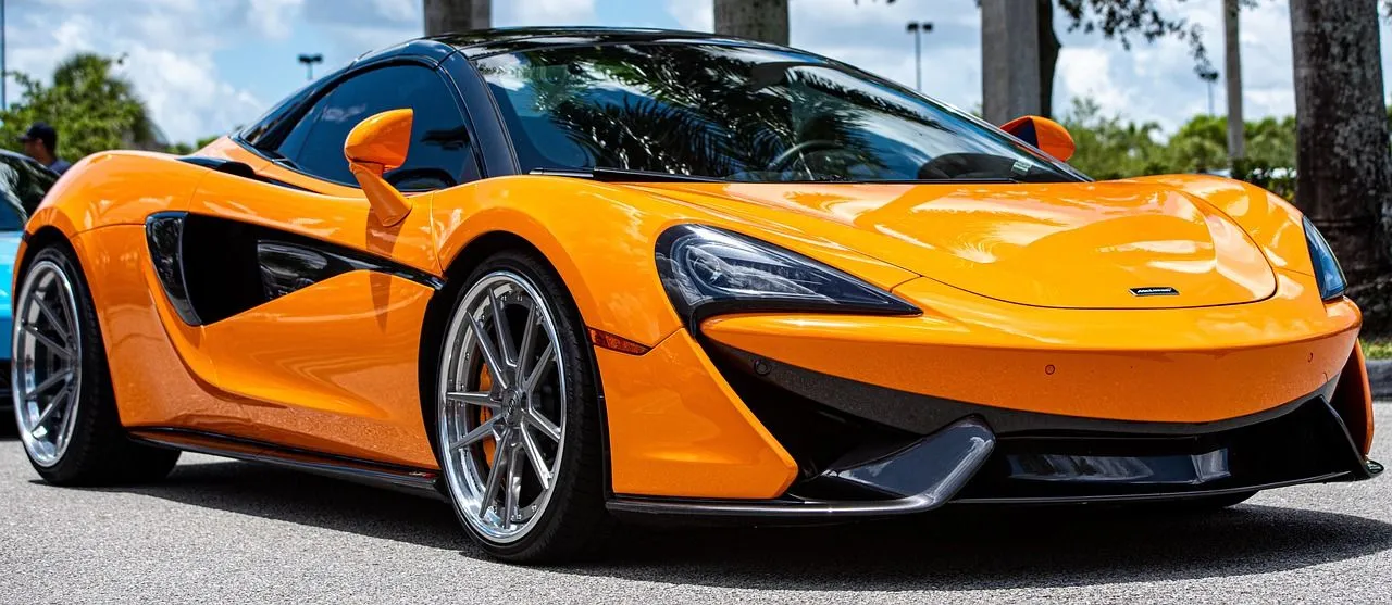 A red toyota sports car is driving down a road