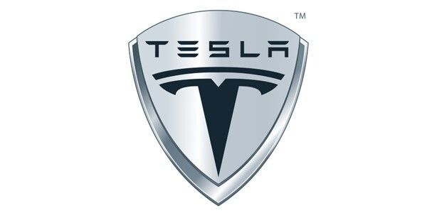 The tesla logo is a silver shield with a black t on it.