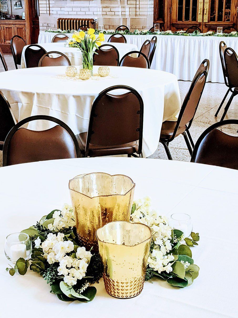 White round tables with brown chairs — Fort Wayne, IN — Goeglein's Catering