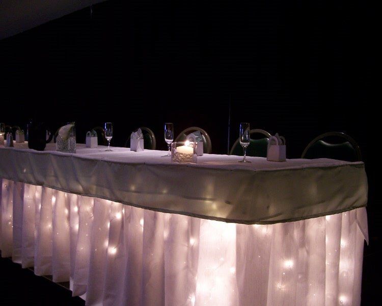 Long table with pink covering and lights — Fort Wayne, IN — Goeglein's Catering