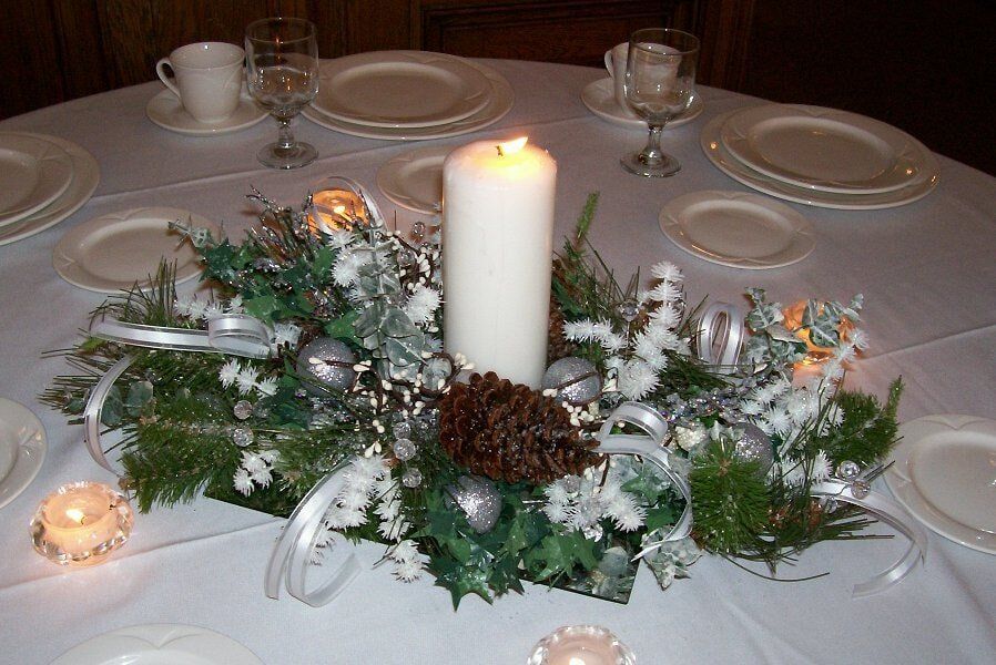 Christmas themed centerpiece with white candle — Fort Wayne, IN — Goeglein's Catering