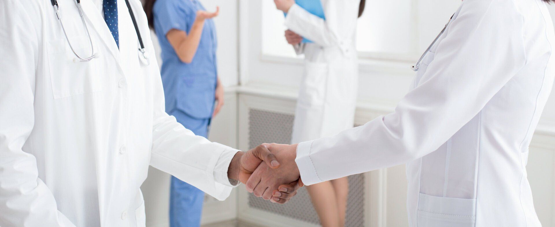 Two doctors shaking hands after a successful collaboration