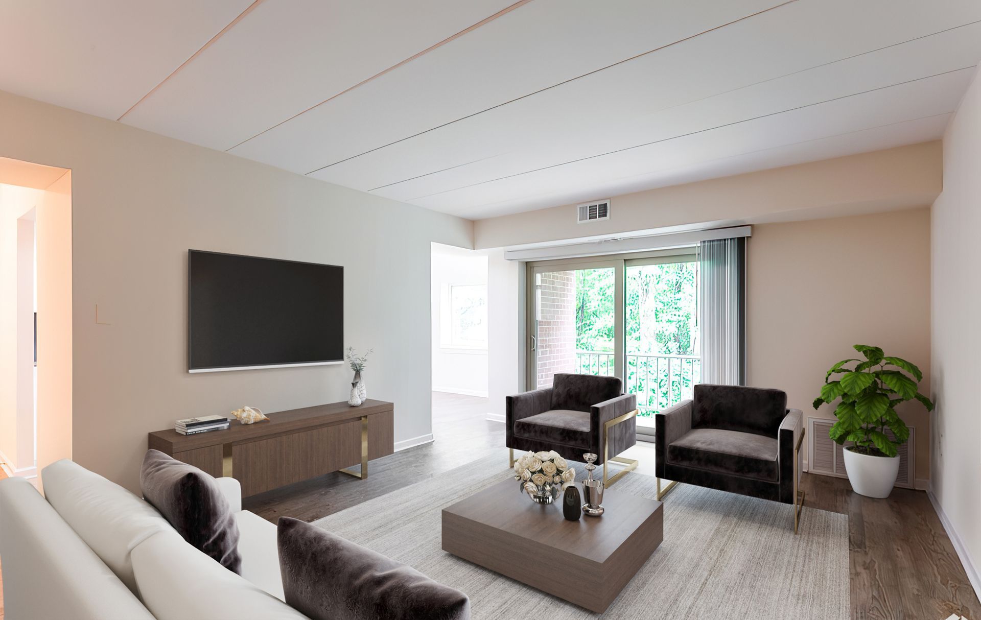 Living room with sofa, chairs, TV, and sliding door to balcony.