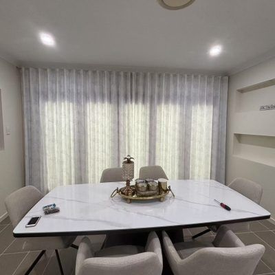 A Dining Room with A Marble-Topped Table, Gray Chairs and Sheer White Curtains — U Curtains in Acacia Ridge, QLD