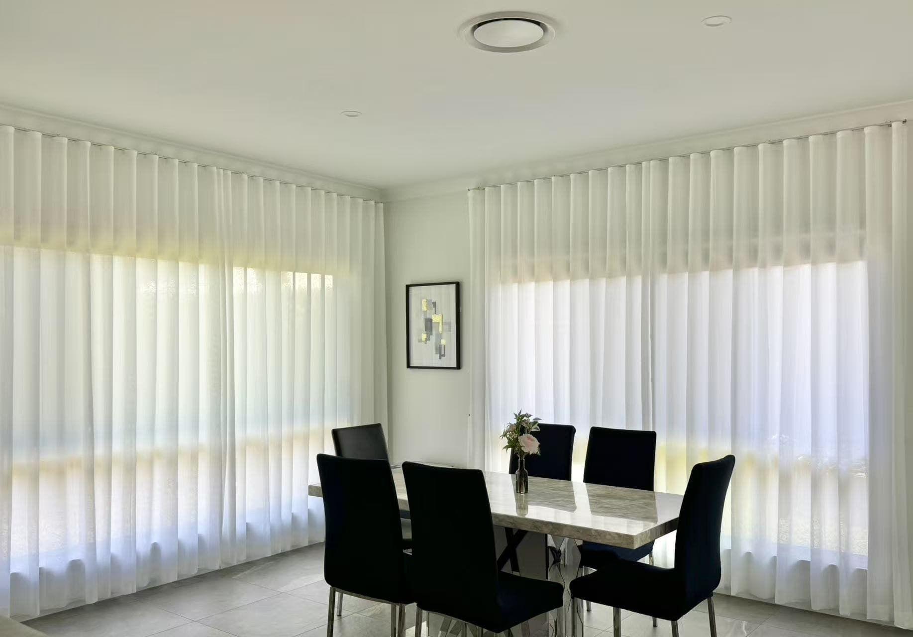 A Dining Room with A Marble Table, Black Chairs and White — U Curtains in Acacia Ridge, QLD