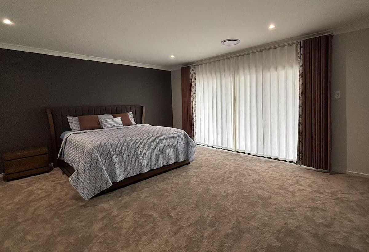 Bedroom with Bed, Dark Accent Wall, Curtains and Carpet Flooring — U Curtains in Acacia Ridge, QLD