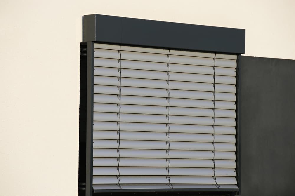Close-Up of Gray Horizontal Blinds on A Building Corner with A Dark Grey Header — U Curtains in Acacia Ridge, QLD
