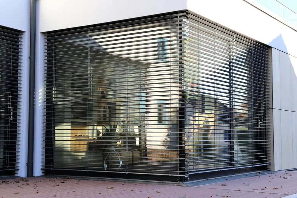 Corner of A Modern Building with Large Windows Covered by Horizontal Metal Blinds — U Curtains in Acacia Ridge, QLD