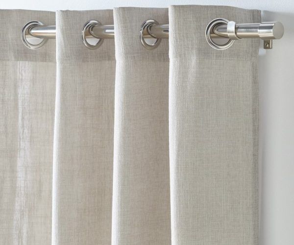 Beige Linen Curtains Hanging from A Silver Rod with Grommets, Partially Covering a White Wall — U Curtains in Acacia Ridge, QLD