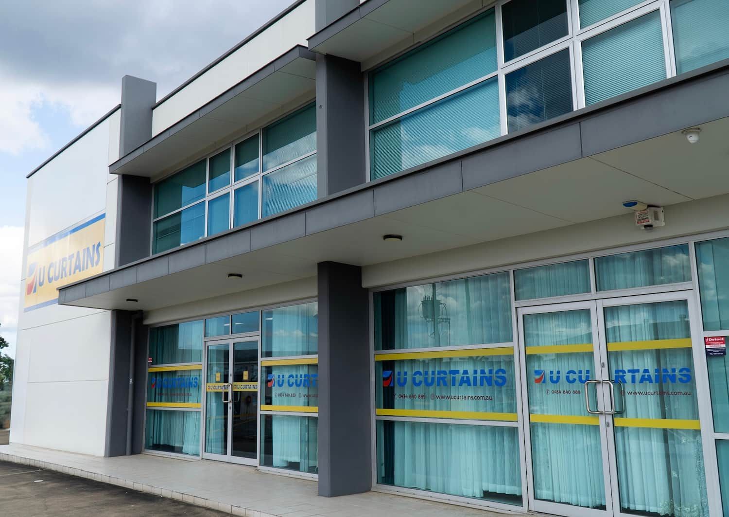 Two-Story Building Su Curtains Store, White and Gray Exterior with Large Windows — U Curtains in Acacia Ridge, QLD