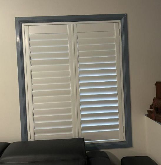 White Shutters Inside a Window with A Blue Frame Angled Slightly — U Curtains in Acacia Ridge, QLD