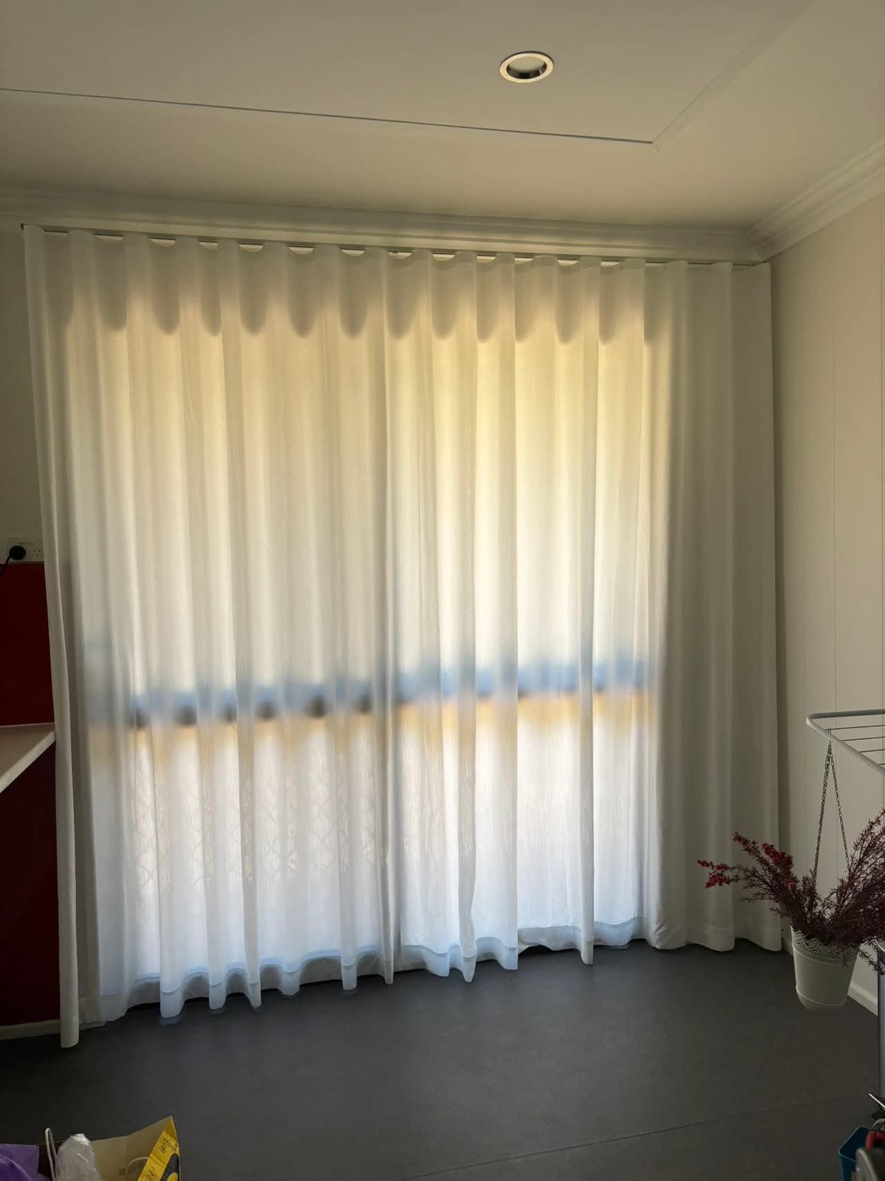 White Sheer Curtains Hang in Front of A Window Partially Blocking the Sunlight — U Curtains in Acacia Ridge, QLD