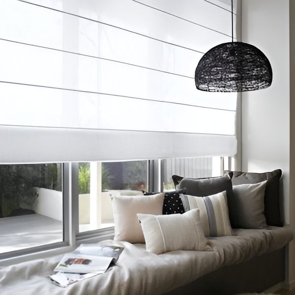 Cozy Window Seat with White Roman Shade, Pillows and Hanging Black Light Fixture — U Curtains in Acacia Ridge, QLD