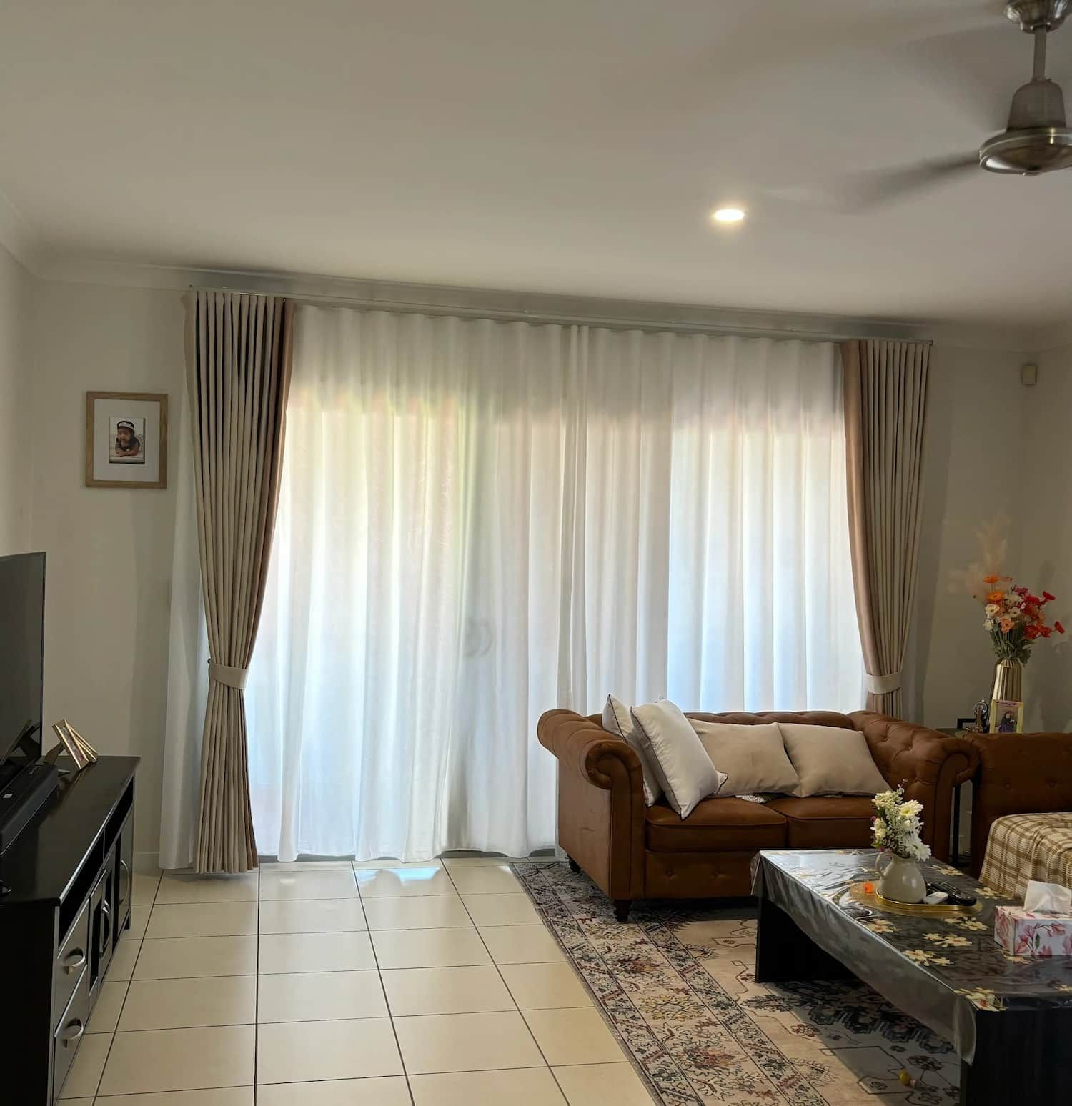 Living Room with Brown Leather Sofa, Sheer White Curtains and A Black Media Console — U Curtains in Acacia Ridge, QLD