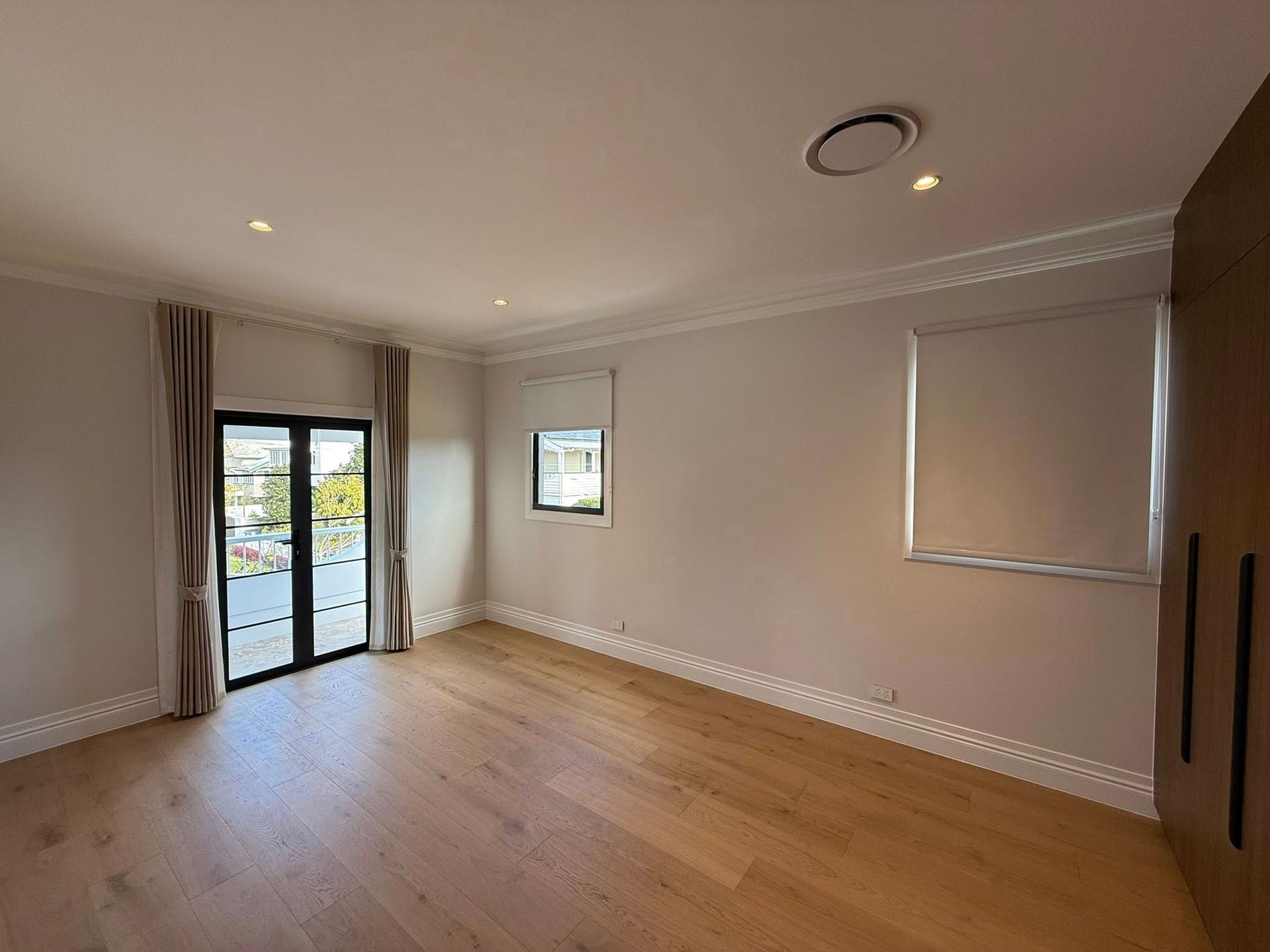 A Window with Light Beige Curtains Slightly Drawn Revealing a Plant in A Pot on The Windowsill — U Curtains in Acacia Ridge, QLD