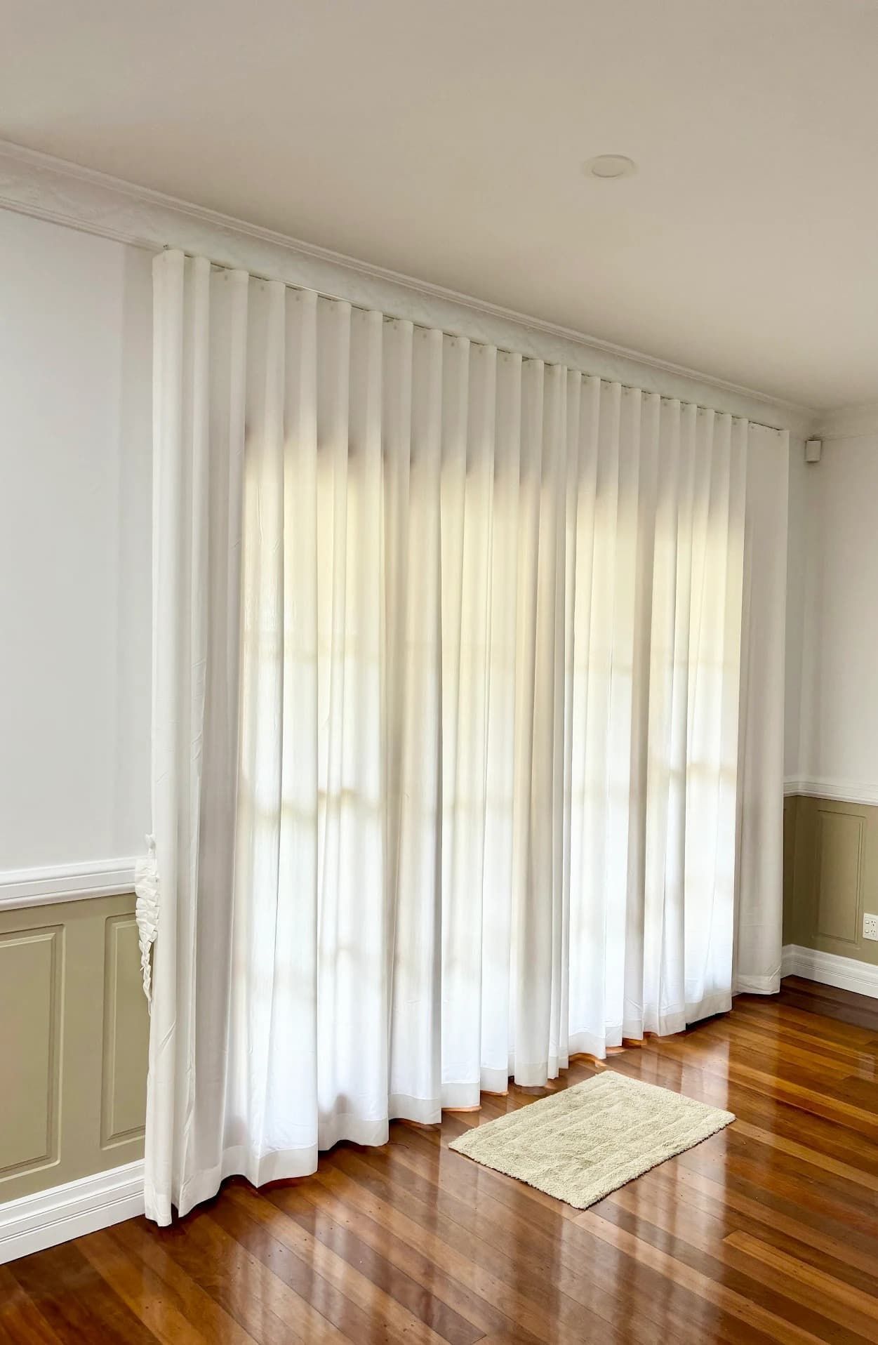 White Sheer Curtains Draped Over a Window in A Room with Hardwood Floors — U Curtains in Acacia Ridge, QLD