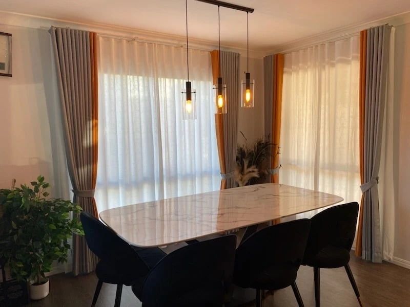 A Dining Room with A Marble-Topped Table, Black Chairs, and Sheer White Curtains Framed — U Curtains in Acacia Ridge, QLD