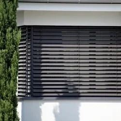 Black Horizontal Blinds on A Building's Window Partially Obscuring the View — U Curtains in Acacia Ridge, QLD