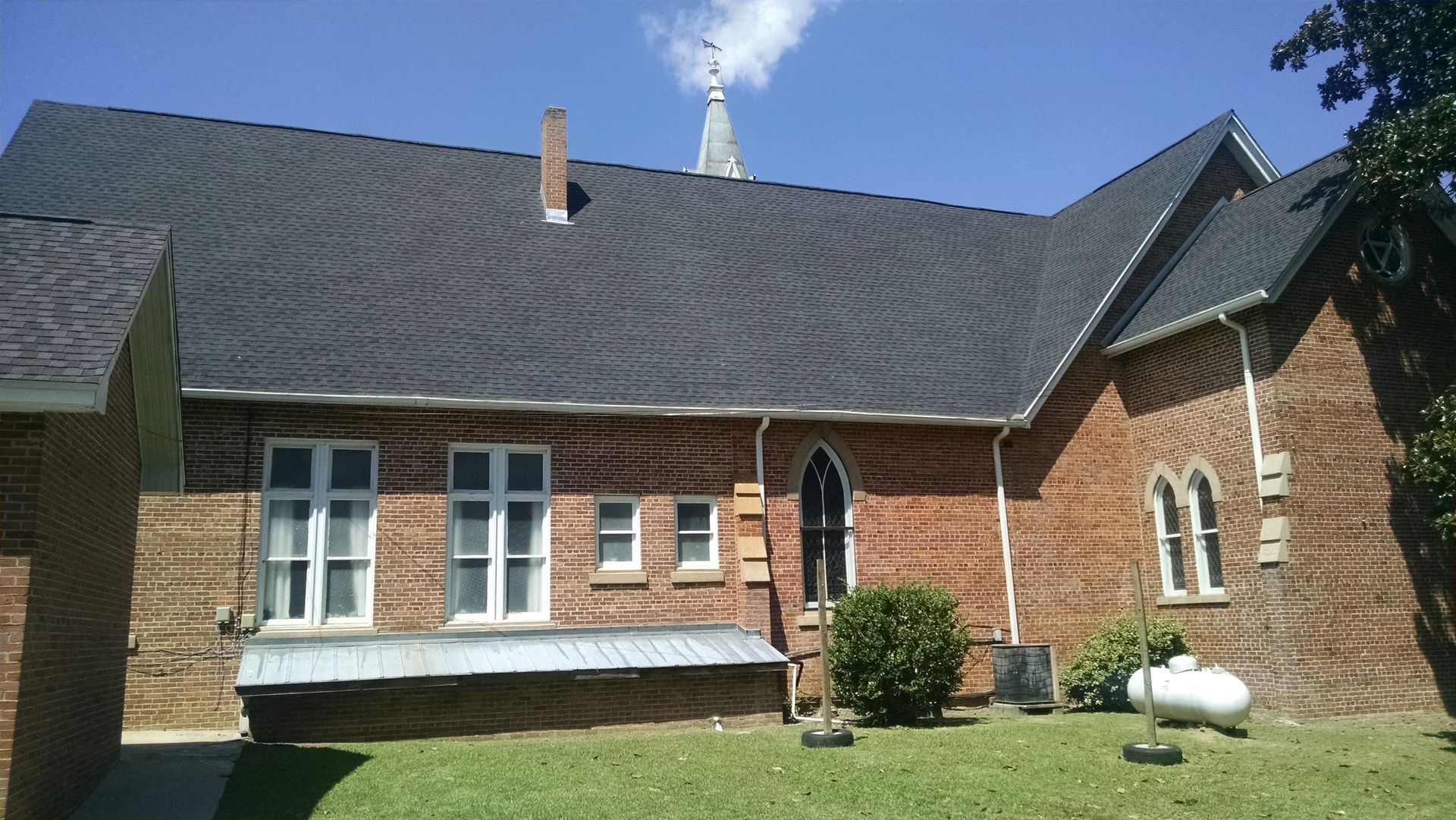 A brick building with a steeple on top of it