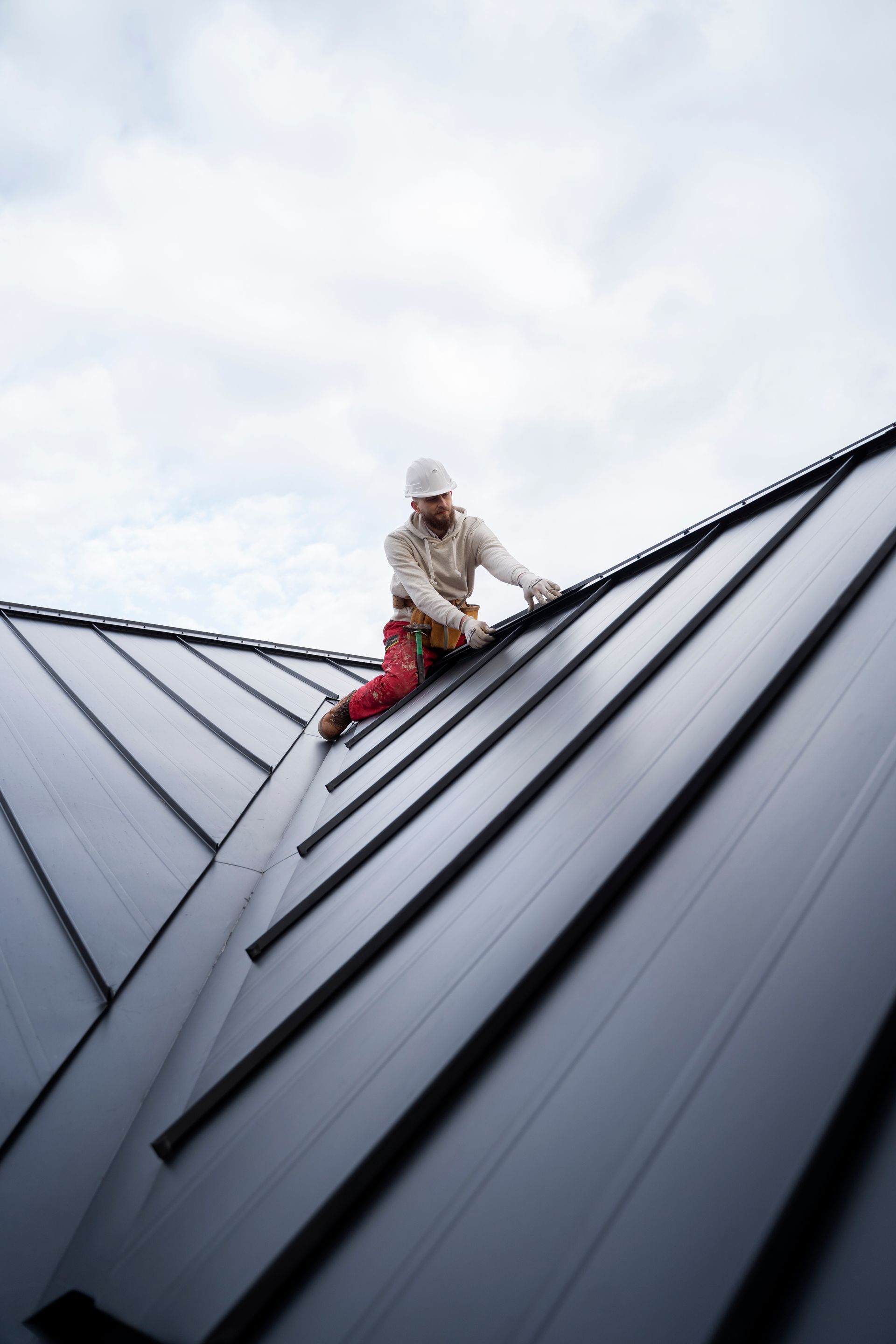A man is working on the roof of a building.