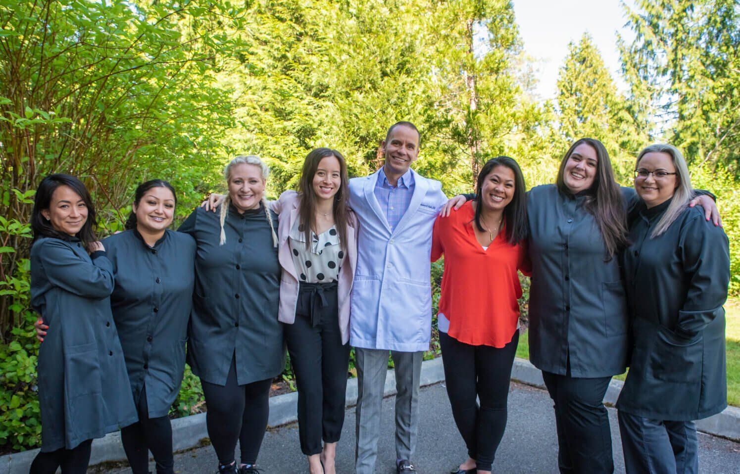 Our dedicated team at our Bellevue dental office smiling for group a picture.