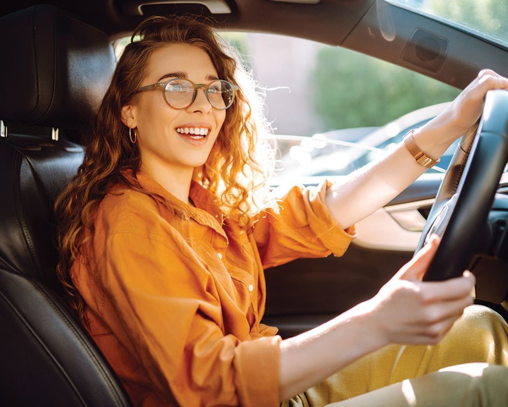 Woman Driving a Car — Wyoming, MN — First Service Insurance Agency