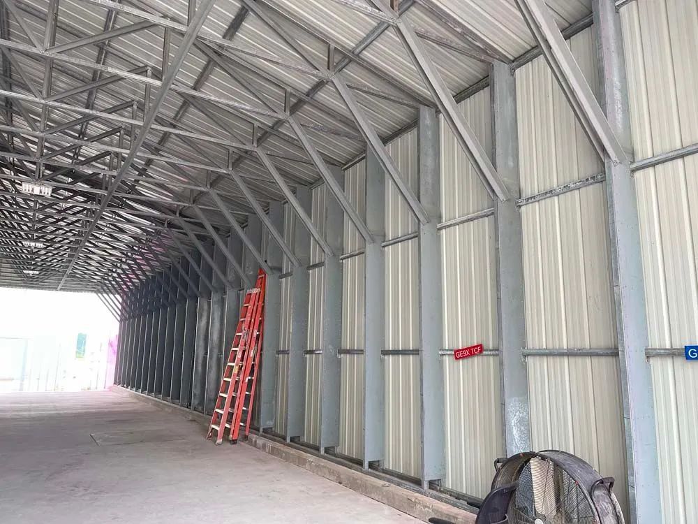 A man is welding a piece of metal in a dumpster
