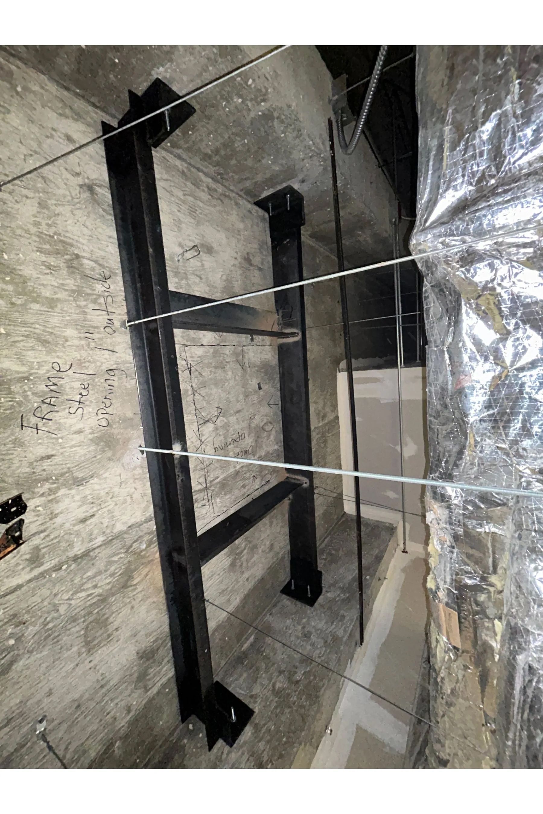 The inside of a large building with a metal roof