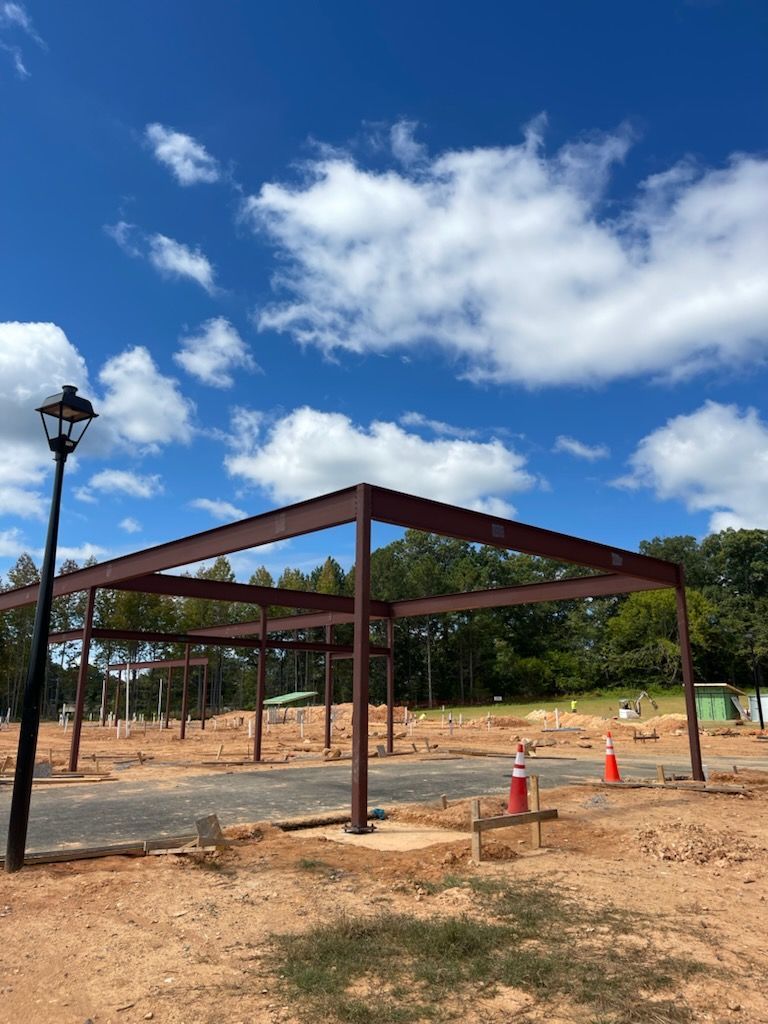 A bunch of pipes are hanging from the ceiling of a building