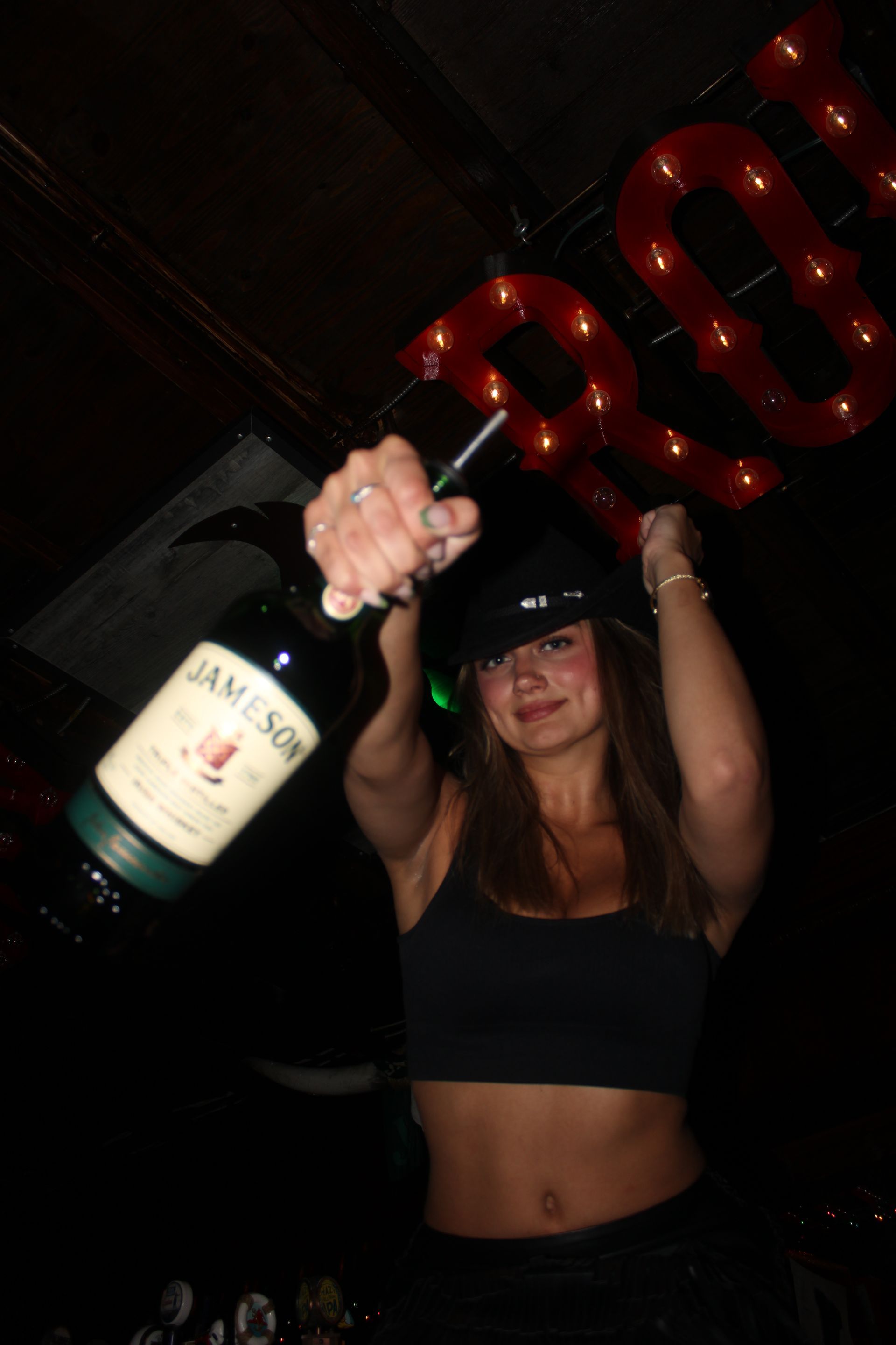 Cowboy Row bartender with bottle in her hand