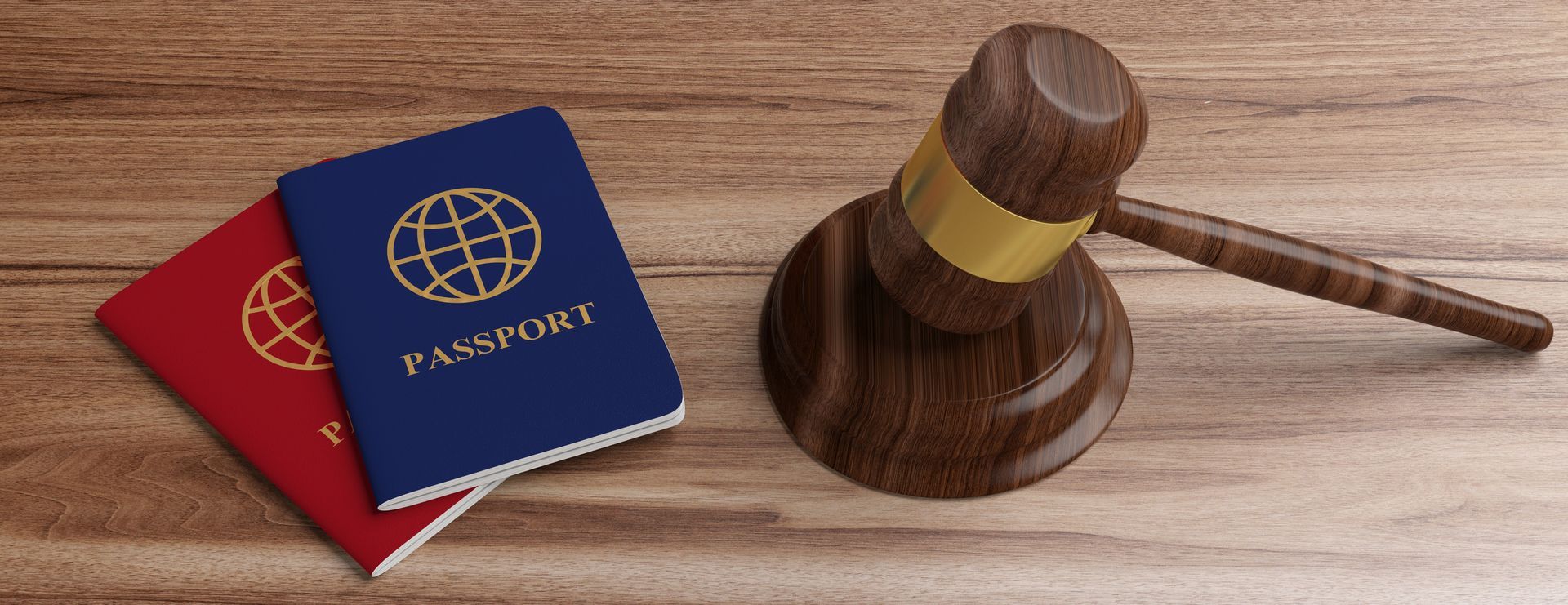 Two passports and a judge's gavel on a wooden desk symbolizing travel and justice. Two passports and a judge's gavel on a wooden desk symbolizing travel and justice.