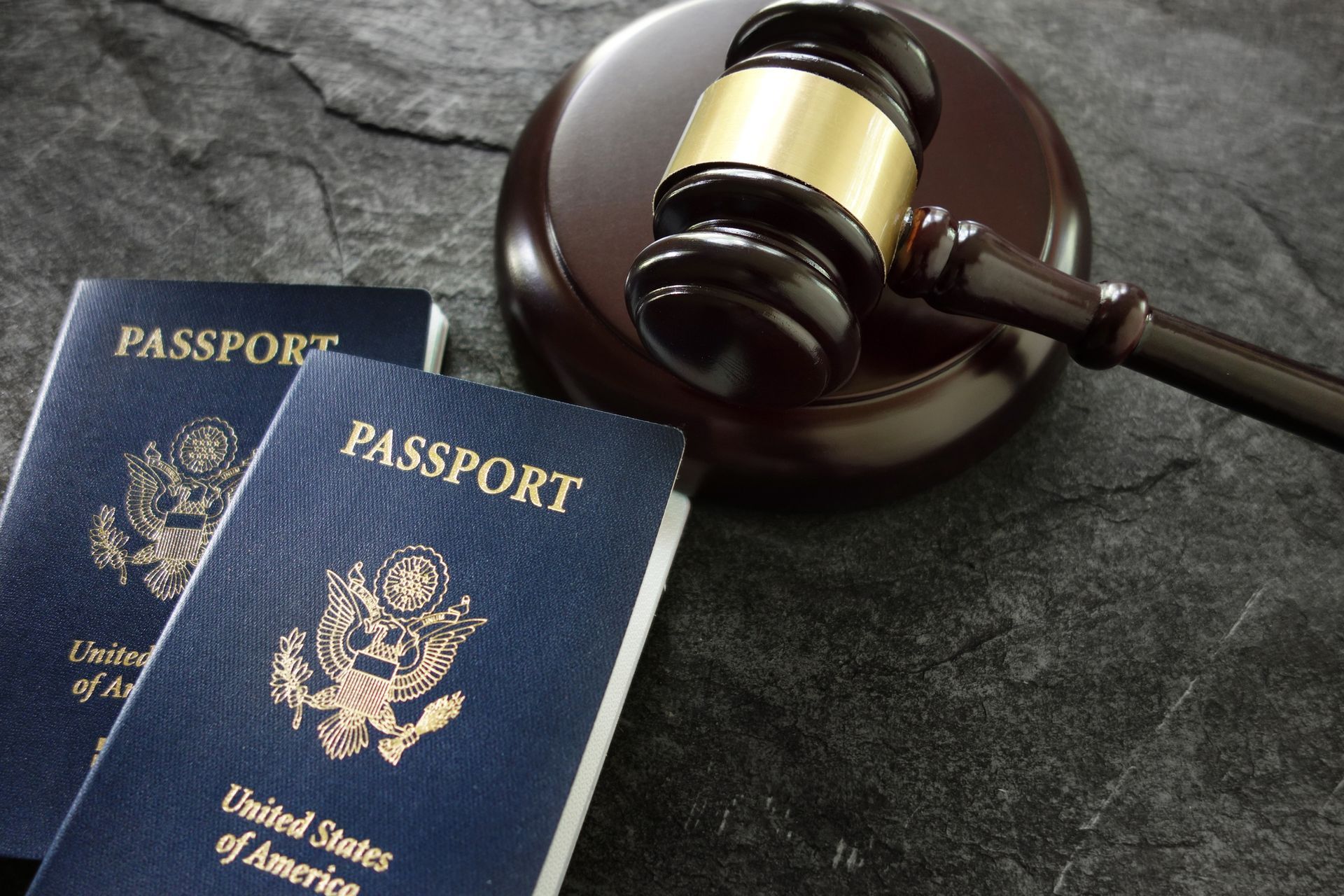 U.S. passports and a wooden judge’s gavel representing immigration attorney services.