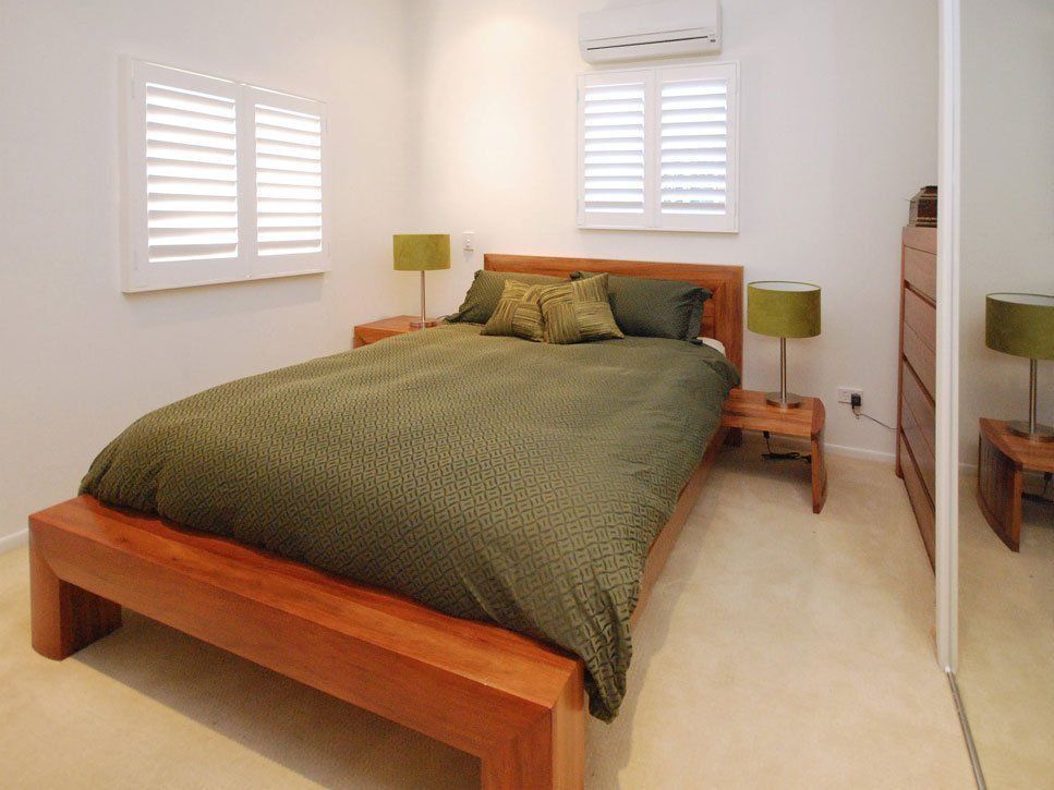 Bedroom with Wooden Bed and Nightstands — Alice Mobile Blinds in Ciccone, NT